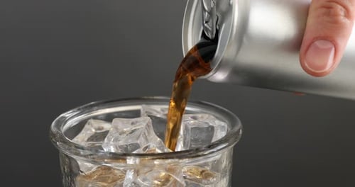 Soda Poured Into Glass with Ice Cubes