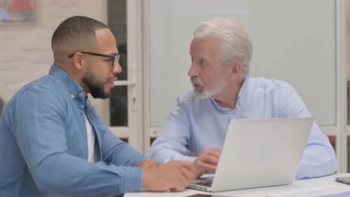 Business People Discussing Online Project in Office