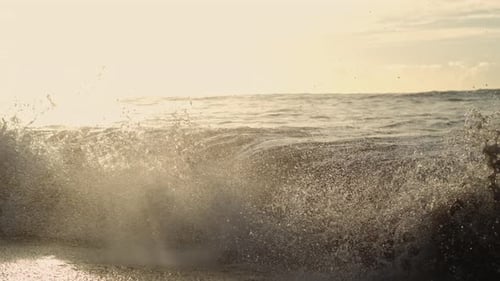 Backlit crest folds at sunrise with sparkling foam