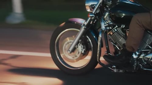 Close Up Motorcycle Front Wheel and Engine During Evening Ride