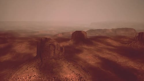 Aerial View of Monument Valley During Sunset with Dramatic Shadows