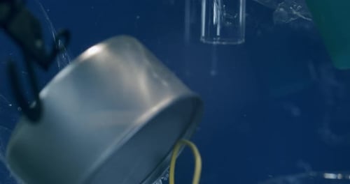 Pieces of plastic and aluminum underwater in ocean biome, world wide problem