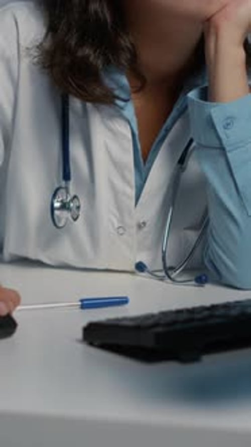 Vertical Video Tired Exhausted Physician Woman Working Late at Night in Hospital Office