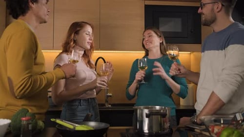 Friends Sharing Wine While Cooking Together