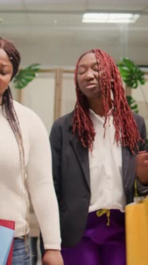 Friends Shopping for Clothes in Stylish Boutique