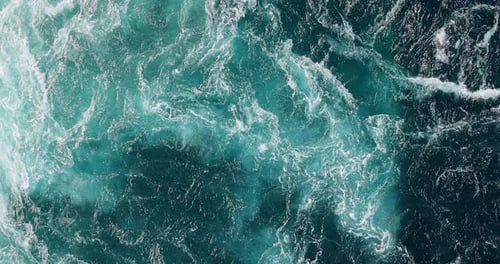 Blue waves of water of the river and the sea meet each other during high tide and low tide.