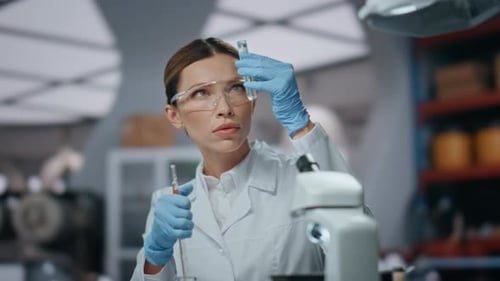Woman Researcher Looking Drugs in Test Tube Wearing Gloves Glasses Close Up