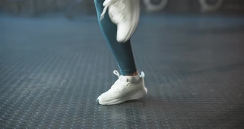 Jogging, warm up and feet of woman in gym for workout, exercise and fitness for marathon training