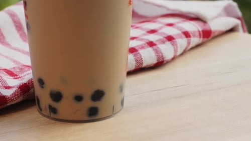 Bubble Milk Tea with Black Tapioca in Plastic Glass Supermarket Chinese Drink Tasty Dessert Close Up