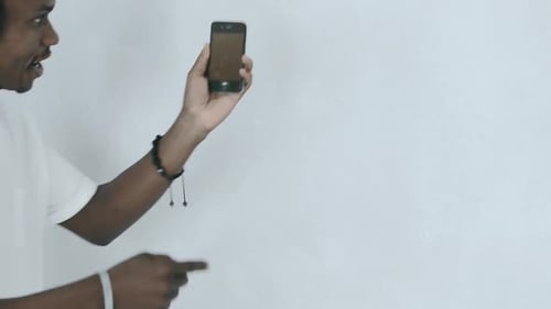 Man Listening to Music on Phone with Headphones