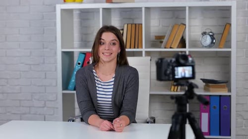 Woman Talking to Camera On Tripod in Office