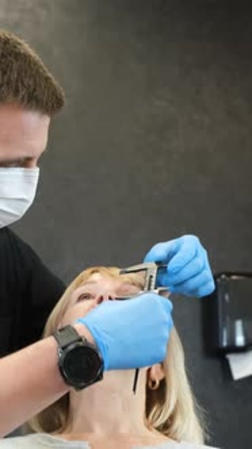 A Doctor is Preparing an Elderly Woman for Plastic Surgery on Her Face Vertical Video