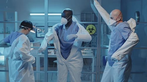 Scientists Putting on Protective Suits in Lab