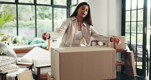 Face, moving and woman with boxes, smile and proud of investment with new home, mortgage and lounge