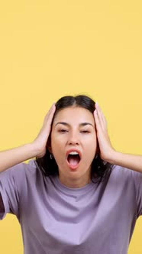 Shocked Woman Screaming in Portrait on Yellow Background