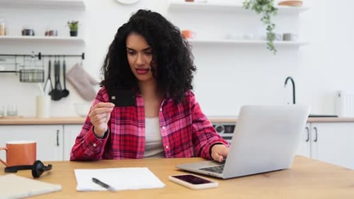 Woman Shopping Online with Credit Card at Home