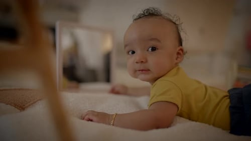 Adorable Infant Lying on Blanket Indoors