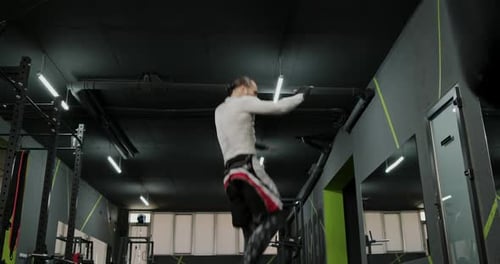 Athletic Man Training Mixed Martial Arts in Gym