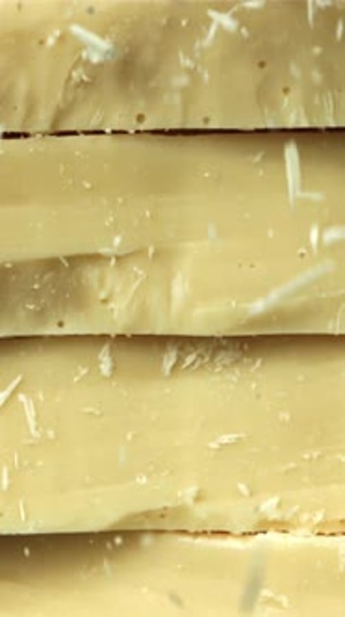 Shredded White Chocolate Falls on a Tower of Chocolate Pieces Filmed on a Highspeed Camera at 1000