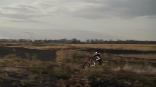 Dirt Bike Rider Jumps on Rural Motocross Course