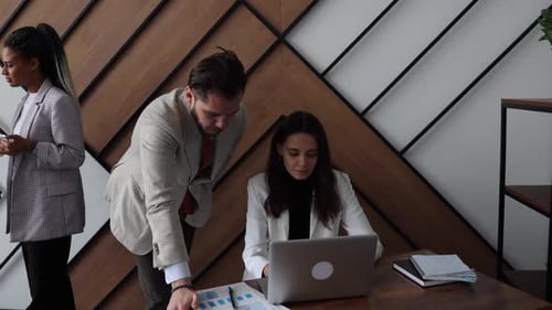 Colleagues Work and Communicate in an Open Space Office