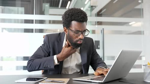 Young Adult Feeling Throat Pain in Office Setting