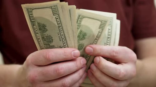 Close Up of Hands Counting US Currency