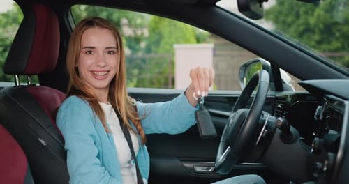Woman Smiling Holding Car Keys in Car
