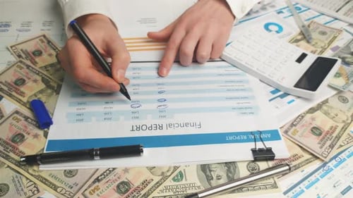 Completing Financial Report with Calculator and Money