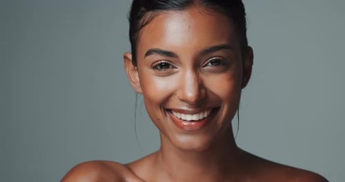 Woman, portrait and makeup with smile for beauty or skincare, confidence or studio background