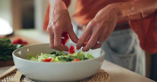 Woman Prepares Fresh Salad in Bright Kitchen