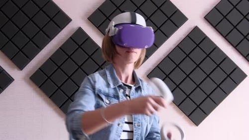 Woman Uses Virtual Reality Headset and Controllers