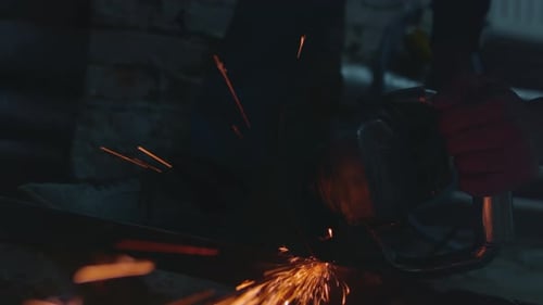 Sparks Fly as Metal is Cut With Grinder