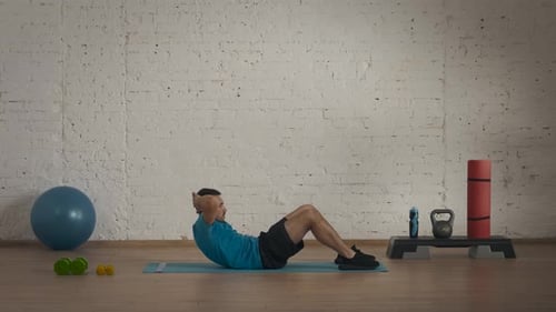 Man Doing Sit-ups in a Gym