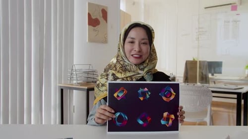 Woman Presenting Graphic Design Concepts in Modern Office