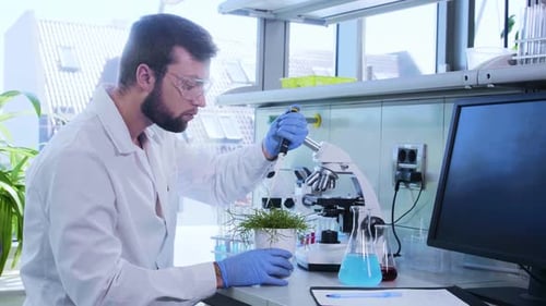 Scientist Working with Microscope in Modern Laboratory