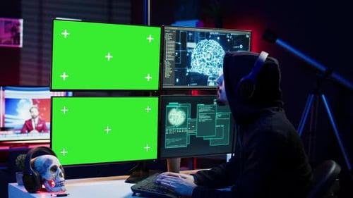 Un hacker écoute de la musique tout en utilisant un PC à écran isolé et une IA pour voler des données