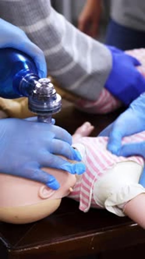 Practicing CPR on a Baby Mannequin