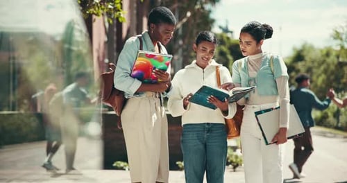 Outdoor, university and women reading book on campus for learning, knowledge or studying together