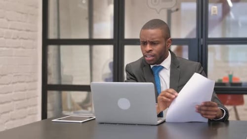 Man Frustrated by Work at Office Desk
