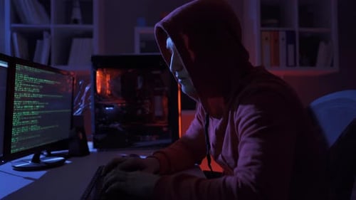 Male hacker using computer to commit a crime.