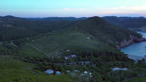 Ibiza Cala Benirras bay and coastline at sunset. Nice aerial view flight drone