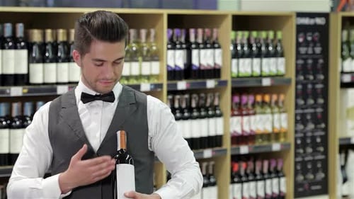 Young Adult Presents Wine in Wine Shop