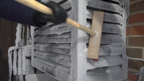 Air Source Heat Pump Outdoor Unit Covered with Snow and Frost