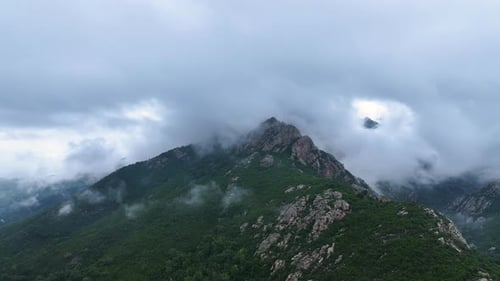 Explore the misty mountain landscape in the early morning light