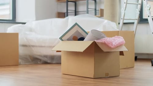 Moving, Repair and Real Estate Concept - Box with Stuff on Floor