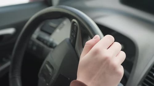 Hands on Car Steering Wheel