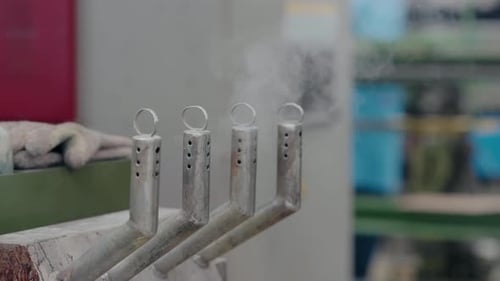 Close Up of Steaming Metal Equipment in Factory