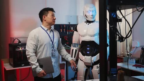 New York April 27 2020 Asian Technician Worker Collaborating with Cyborg Engineer Machine Learning