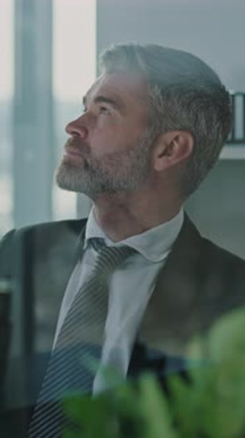 A Thoughtful Businessman Engaged in a Professional Office Environment and Setting Goals